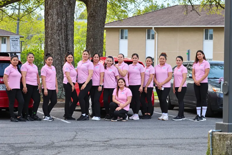 The Edis Cleaning Services team in their pink uniforms in Chantilly, Virginia